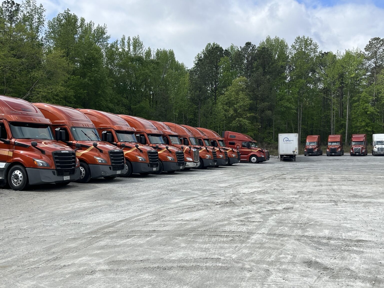 Commercial trucks parked together in a fleet yard